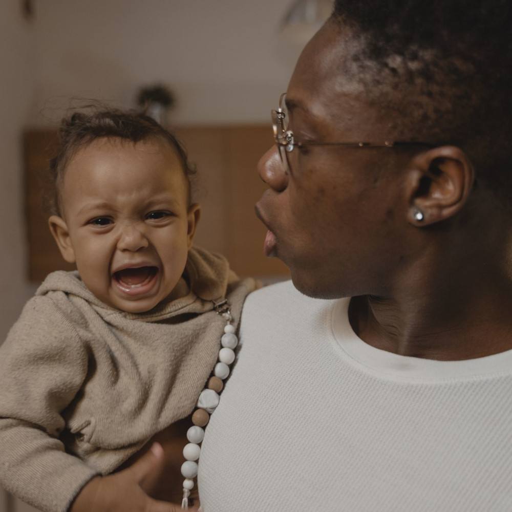 Mother holding crying infant